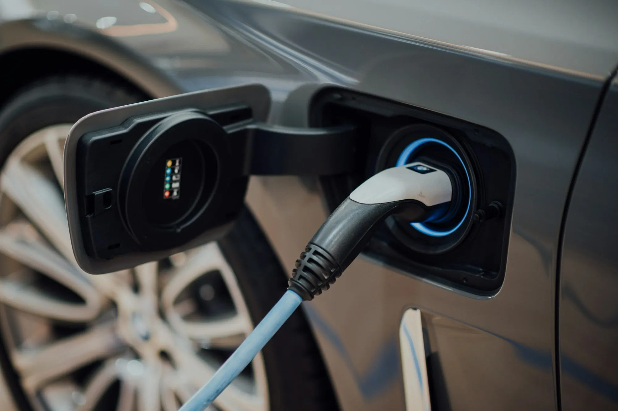 Charging cable plugged into the port of an electric car